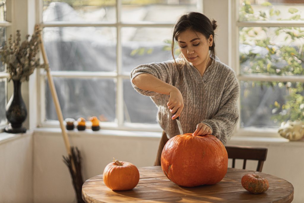 girl cutting the pumpkin