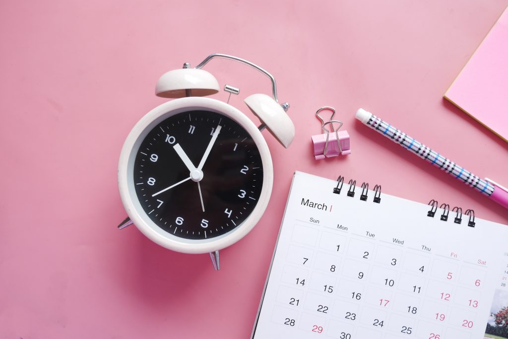 pink clock and calendar
