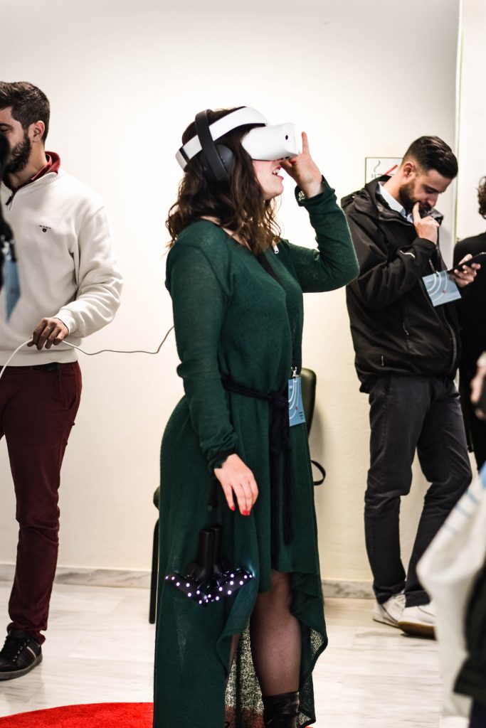 Women in a green long sleeve dress holding a VR